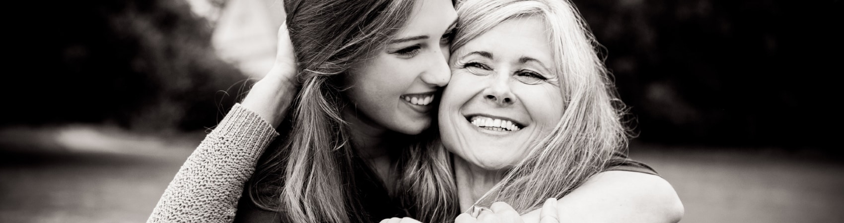 daughter and mother embracing and smiling